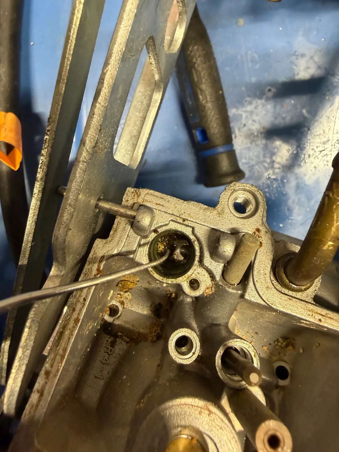 Contaminated motorcycle carburetor passage during rebuild inspection