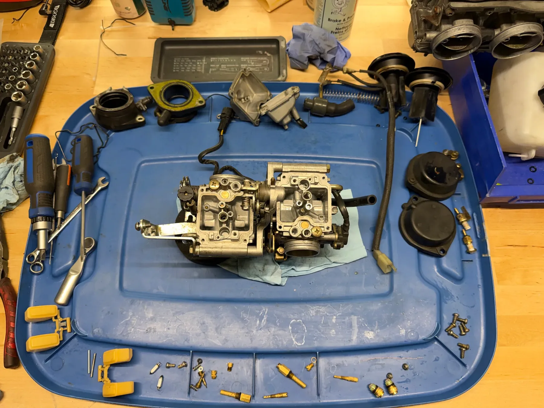 Twin motorcycle carburetors disassembled for cleaning and inspection