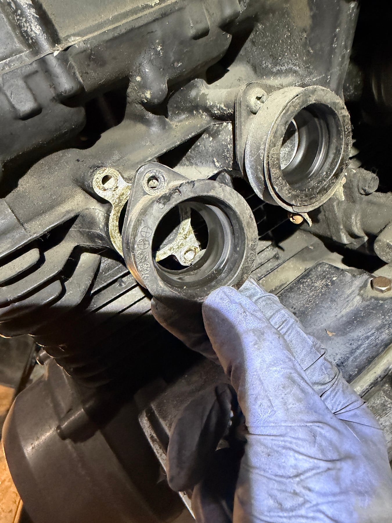 Aged Kawasaki GPZ750 carburetor intake boot inspected during restoration