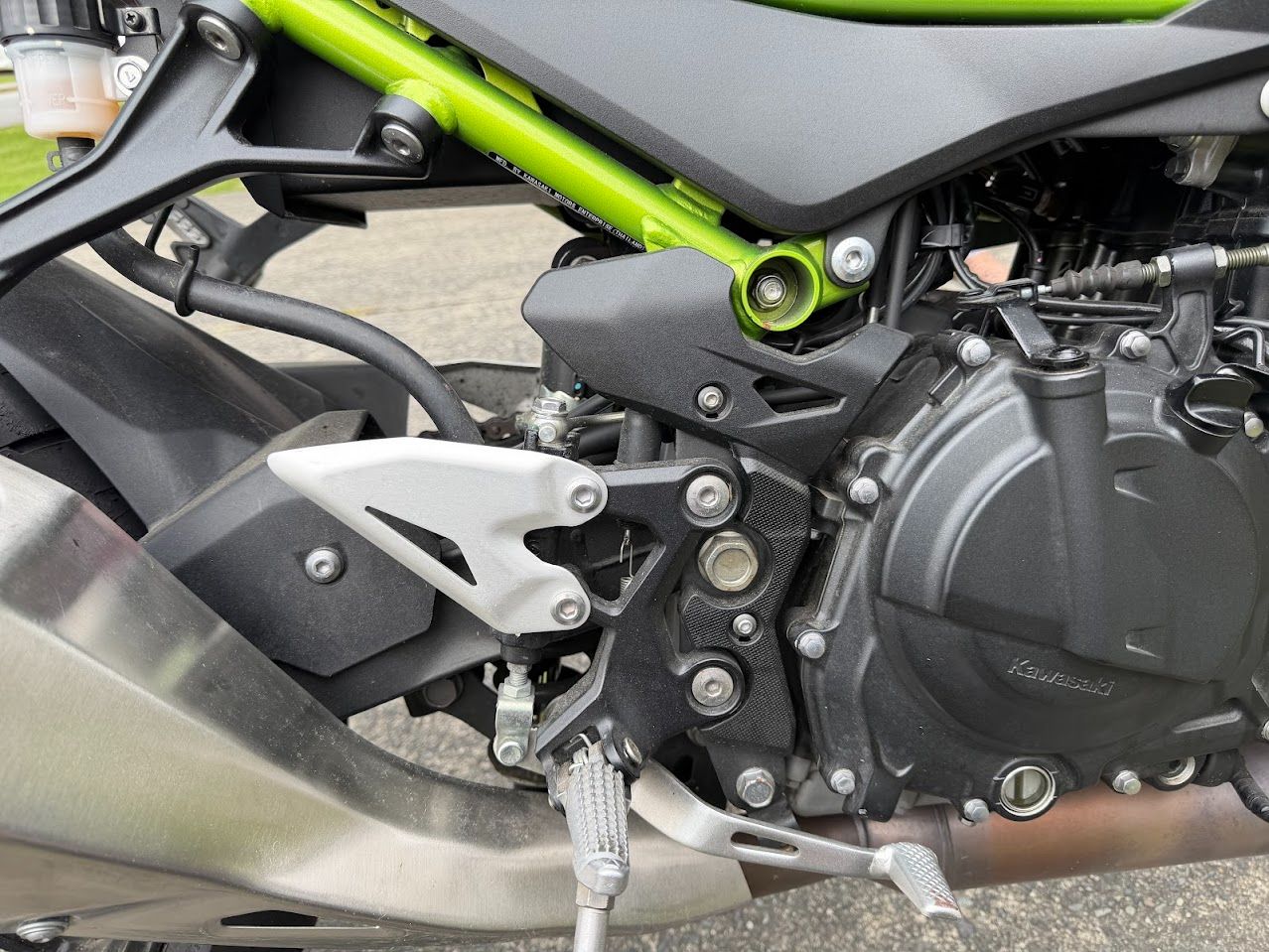 Motorcycle engine and side area used to illustrate battery and charging diagnostics