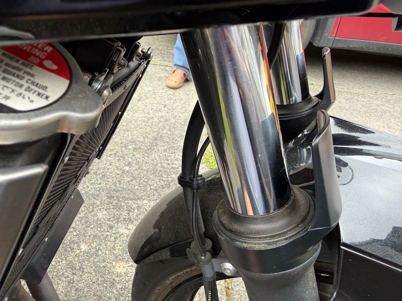 Front fork and brake area inspected during a mobile motorcycle appointment