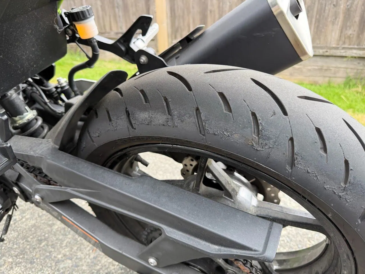 Close-up of a used motorcycle tire inspection before purchase