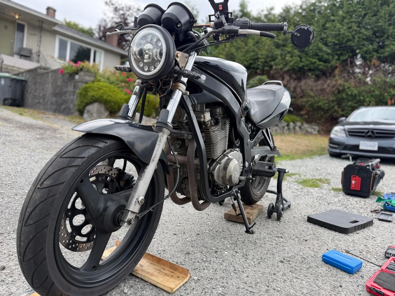 Suzuki GS500 supported for an on-site motorcycle chain replacement