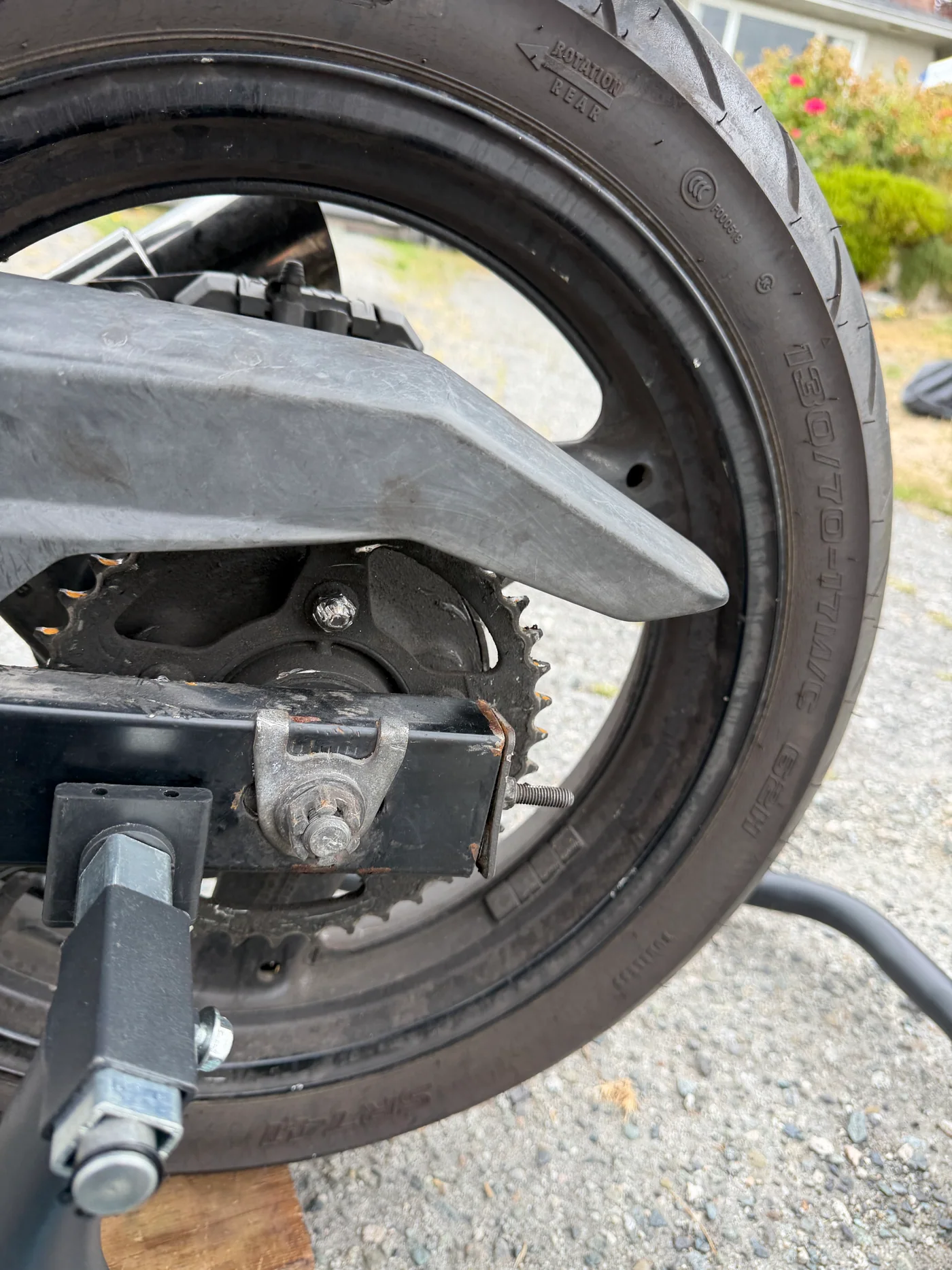 Suzuki GS500 rear sprocket and chain-adjustment area exposed for inspection